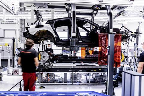 The assembly facility of the Audi e-tron GT at Böllinger Höfe- During the marriage, employees fasten the battery and the drive components to the body with screws at 74 points
